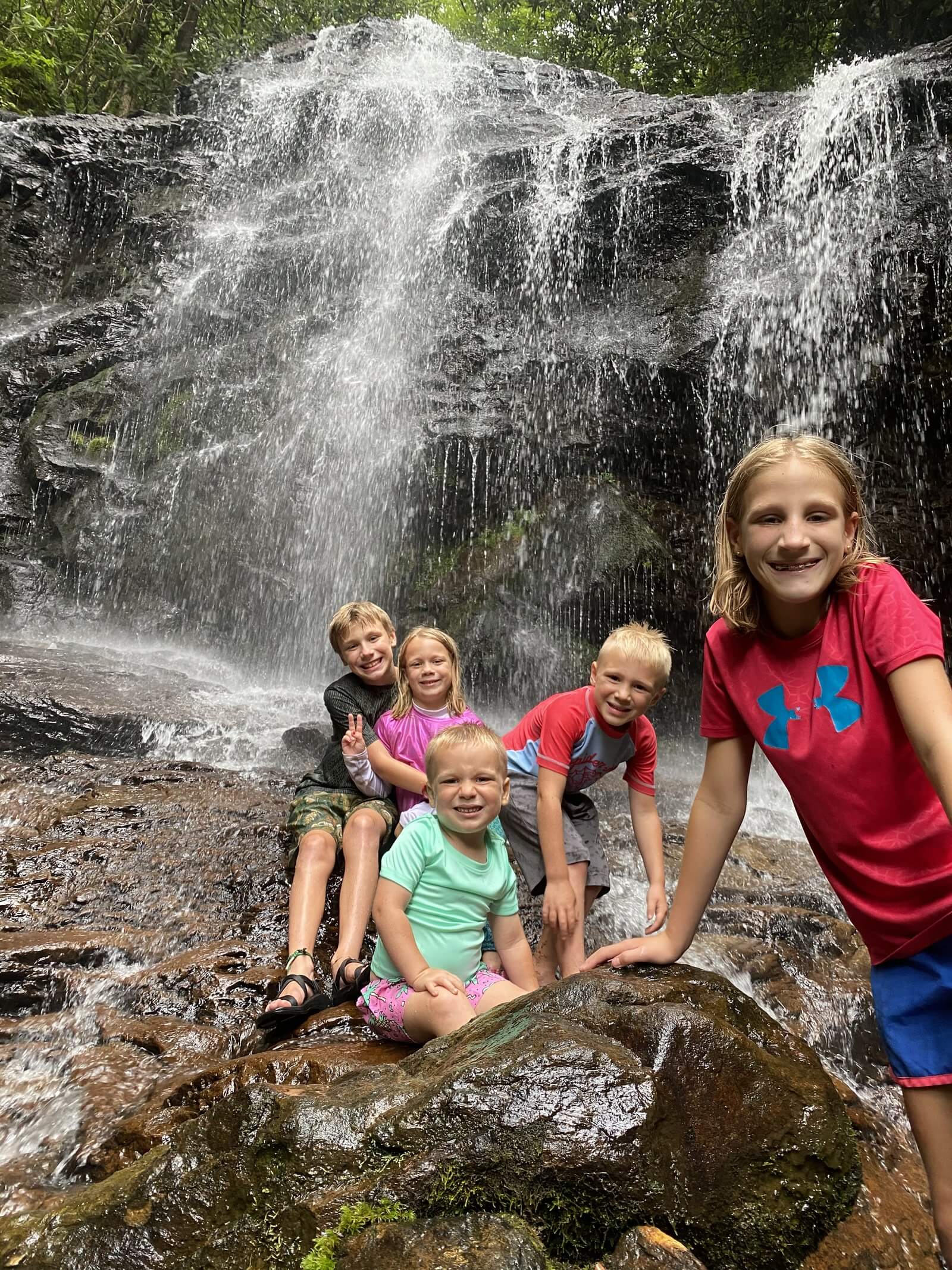 Five of John's children on the rocks at the foot of a waterfall in the Western North Carolina mountains